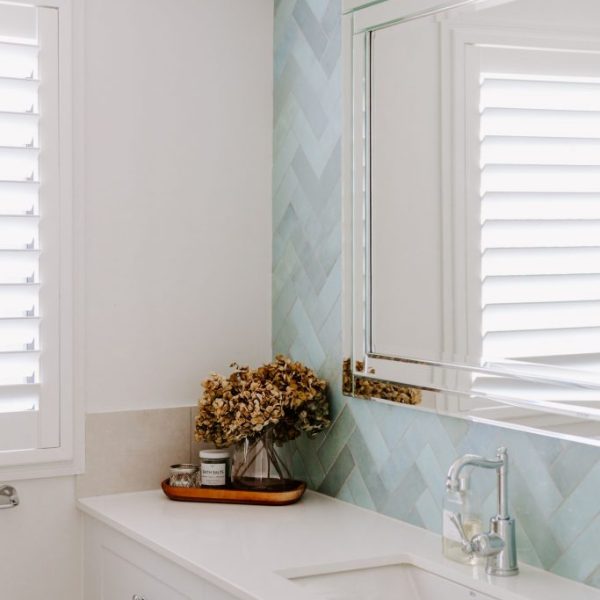 Caloundra unit renovation featuring coastal blue and white bathroom by sunshine coast designer and builder Coco Interiors